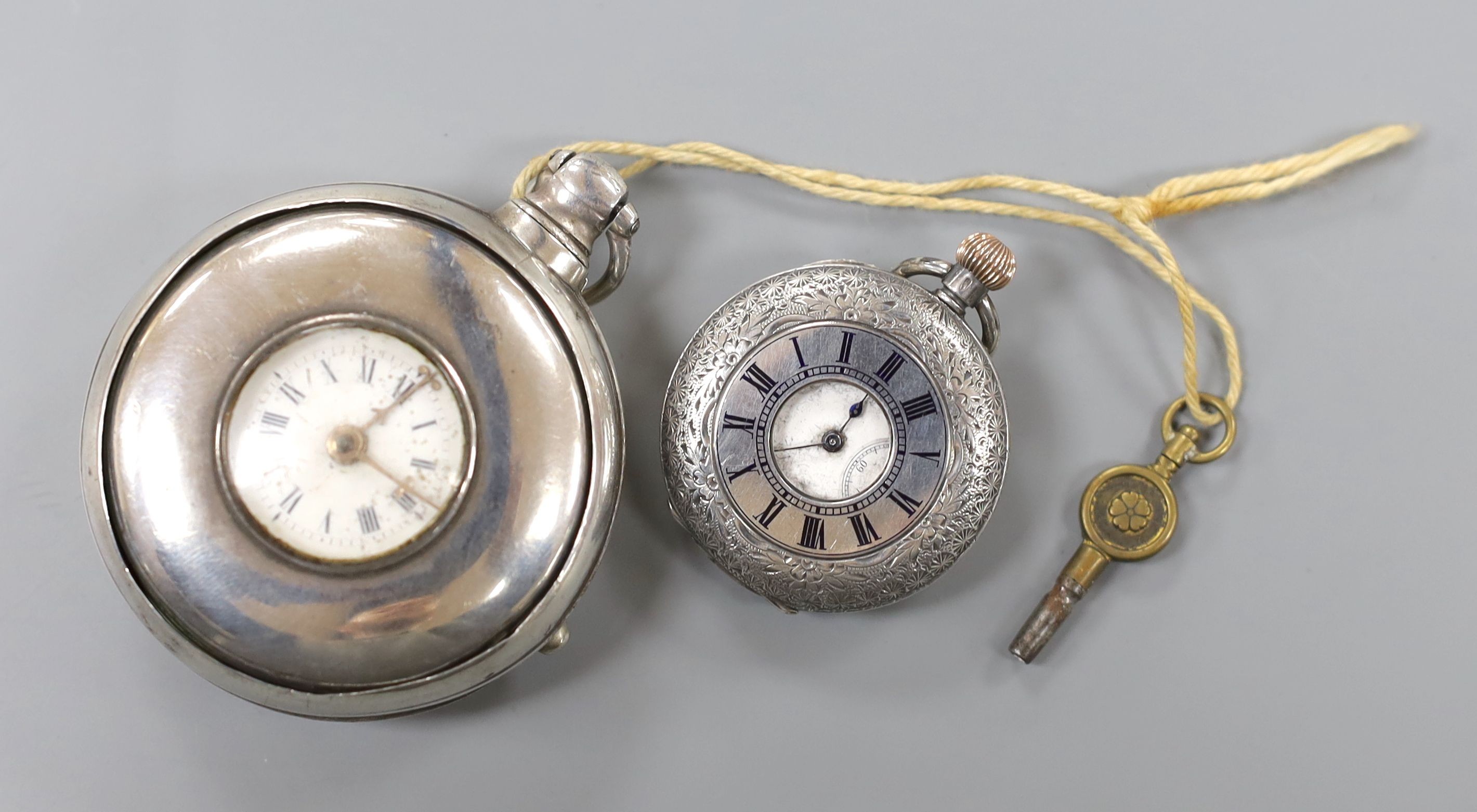 A 19th century silver pair cased half hunter keywind pocket watch, with two Roman dials, overall diameter 55mm, and a later engraved silver fob watch.